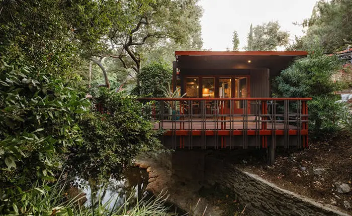 the John Norton House, designed in 1954 by Buff, Straub and Hensman floats over cascading pond.
