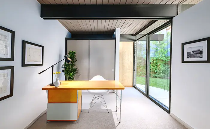 Mid-century, post and beam home office with eames and nelson furnishings