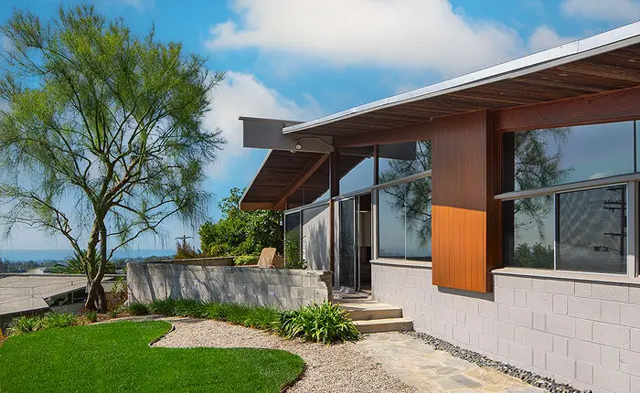 The exterior of an A. Quincy Jones house incorporating post and beam construction and expansive glazing