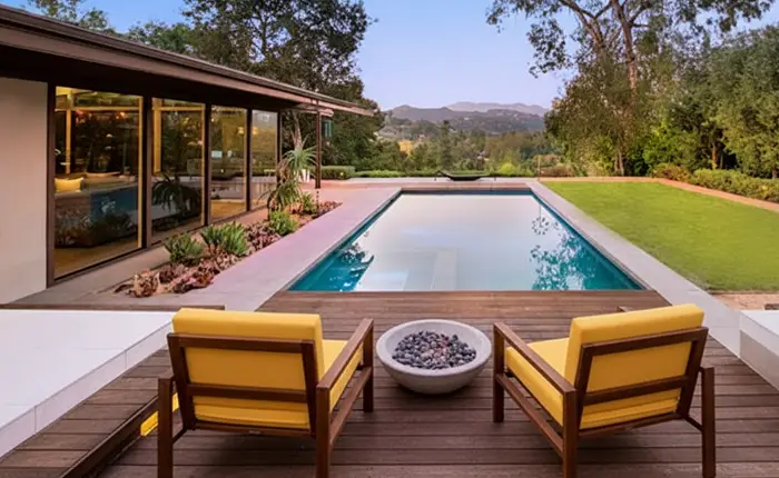 Evening view of a Buff and Hensman modernist home with garden, showing indoor-outdoor living in Los Angeles