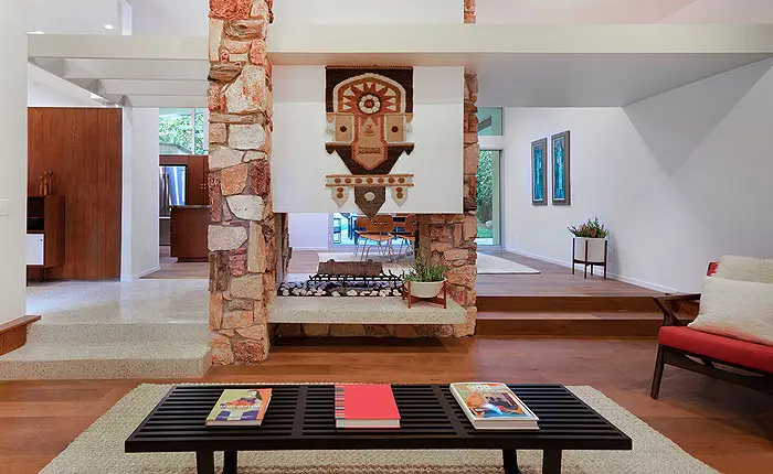 Focal point fireplace in this mid-century modern living room designed by architect Edward Fickett
