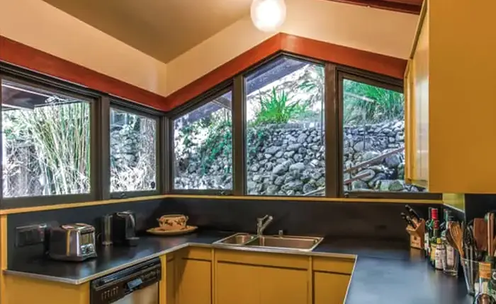 Interior of kitchen with outdoor views of a Harwell Hamilton Harris mid century home